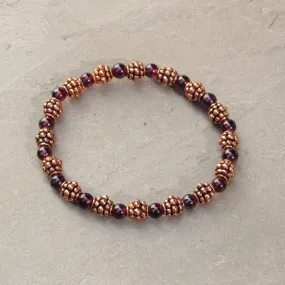 Garnet gemstones and copper bracelet