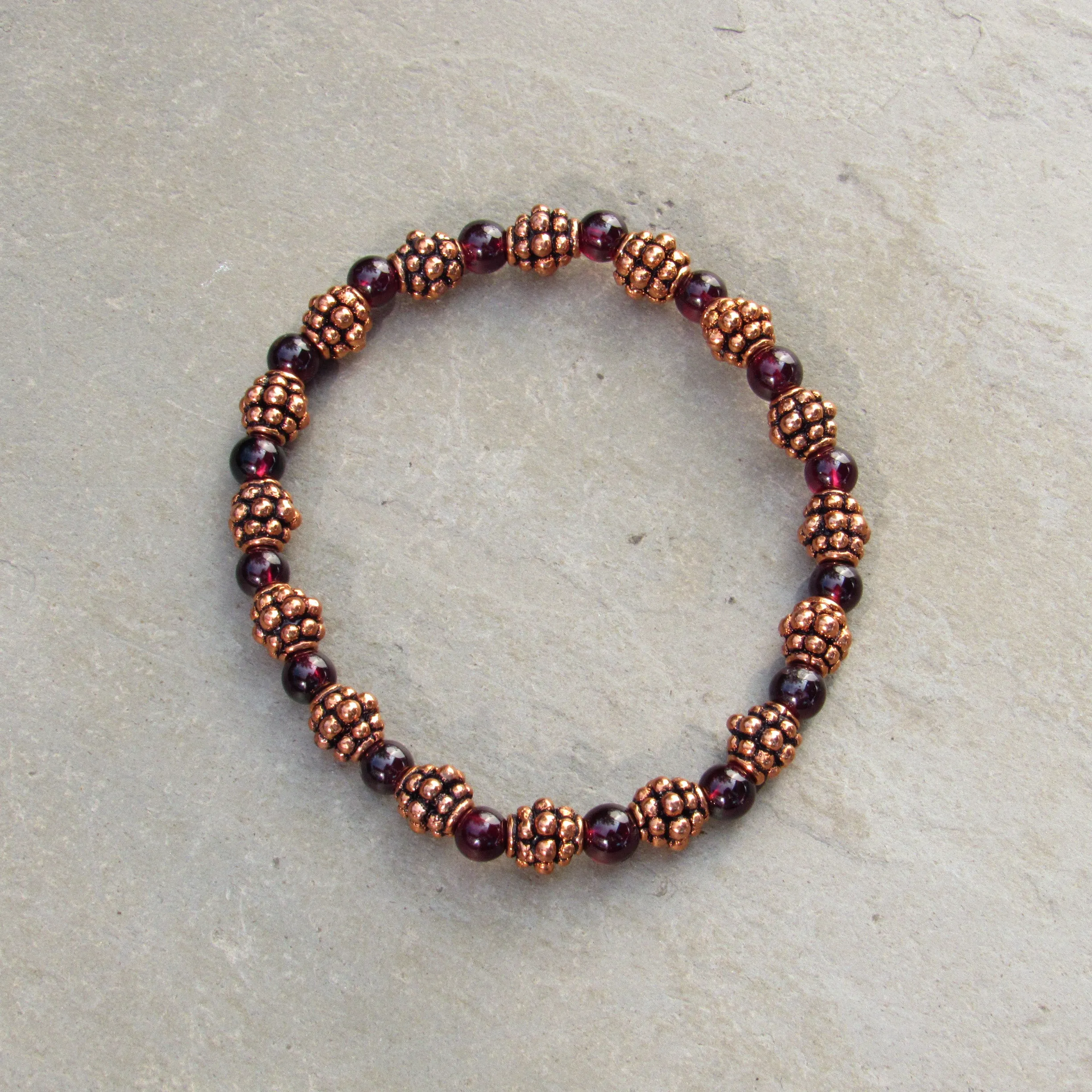 Garnet gemstones and copper bracelet