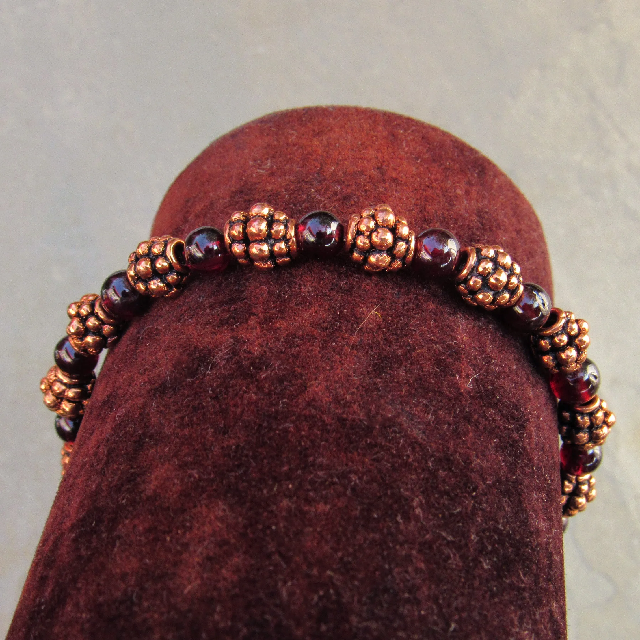 Garnet gemstones and copper bracelet