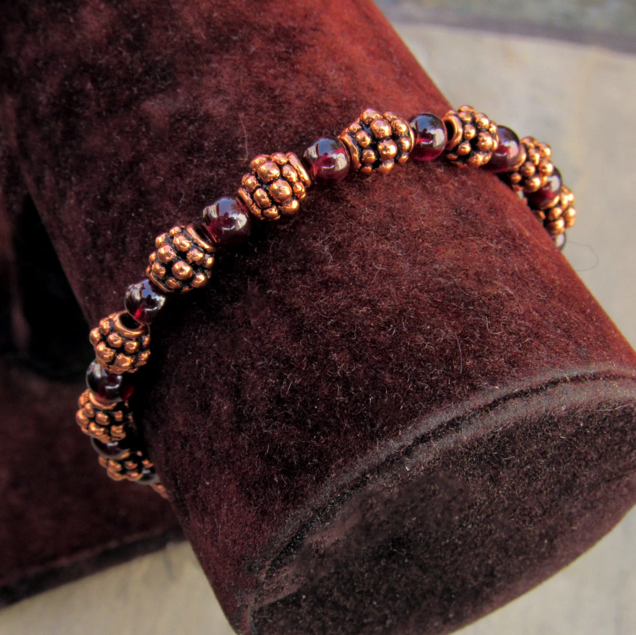 Garnet gemstones and copper bracelet